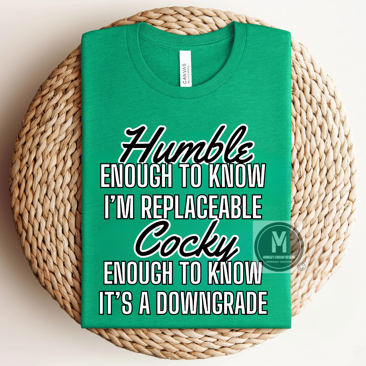 Green t-shirt with humorous text on a woven surface