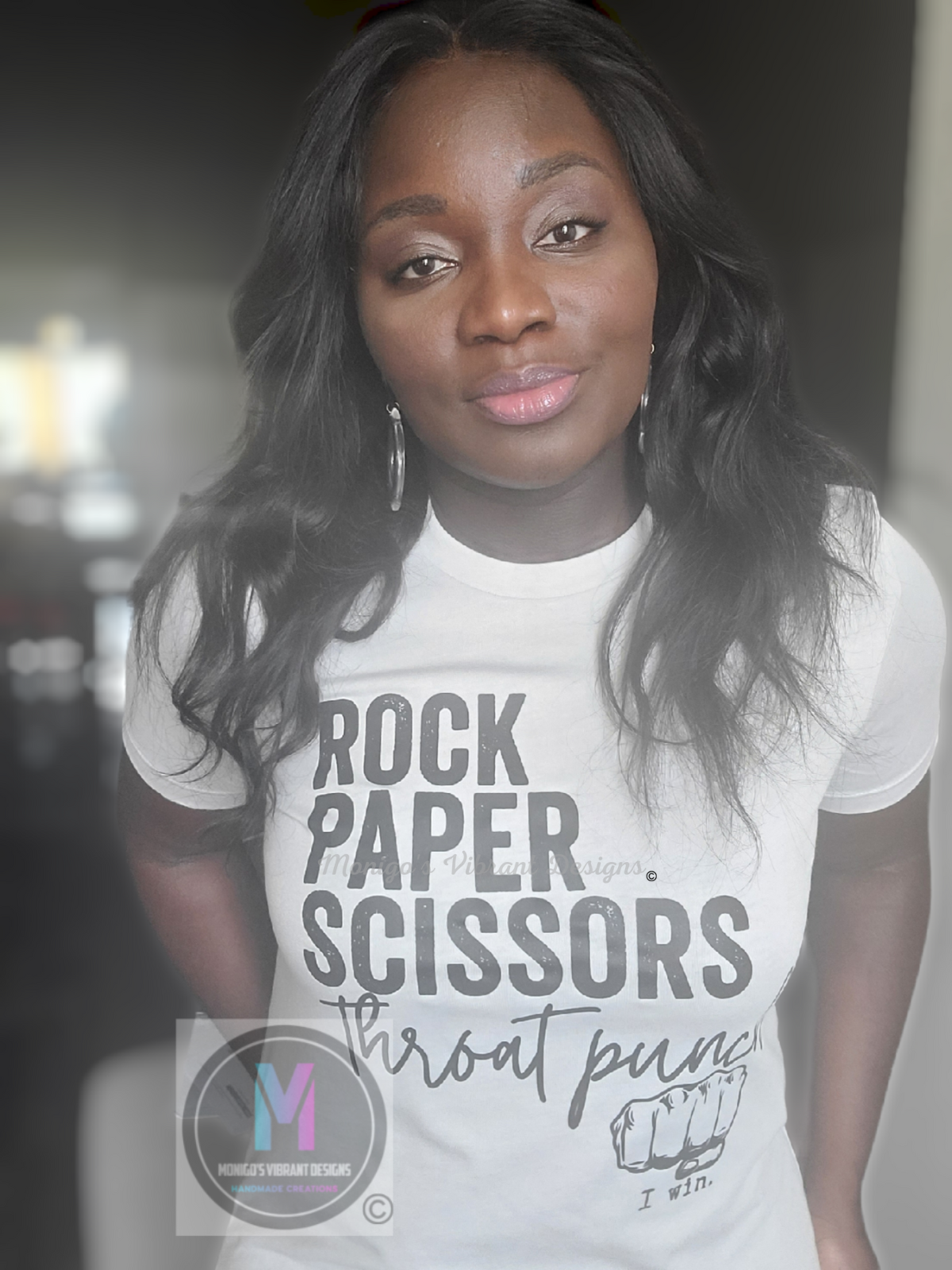 Woman wearing a t-shirt with 'Rock Paper Scissors Throat Punch' text design.