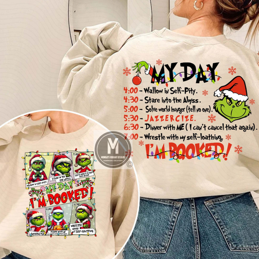 Beige sweatshirt with Grinch-themed text and graphics, worn by a person.