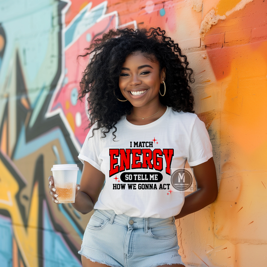 Smiling woman wearing a white unisex graphic t-shirt with bold red and black text that reads ‘I Match Energy So Tell Me How We Gonna Act
