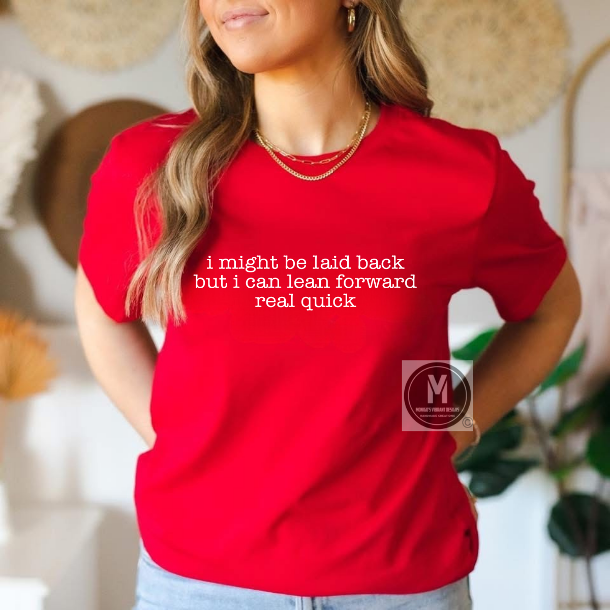 Person wearing a red t-shirt with humorous text in a casual setting